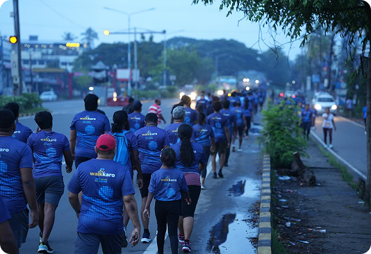 Group of walkkaro participants walking at dusk